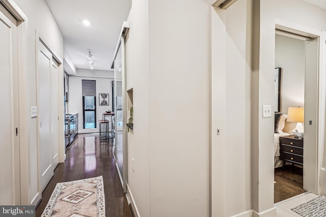 hallway featuring dark hardwood / wood-style flooring