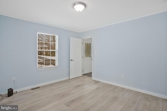 spare room with light wood-type flooring