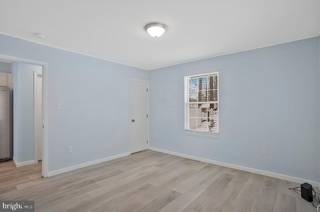 spare room featuring light hardwood / wood-style floors