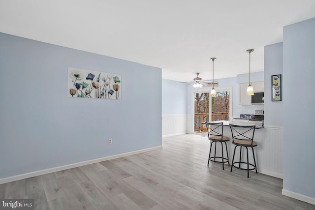 dining area featuring ceiling fan and light hardwood / wood-style flooring