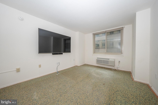 unfurnished living room with carpet floors and an AC wall unit