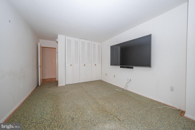 unfurnished bedroom with a closet and carpet flooring