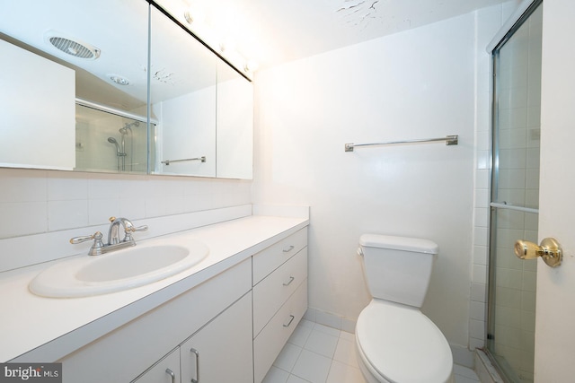 bathroom with toilet, a shower with shower door, vanity, tile patterned flooring, and decorative backsplash