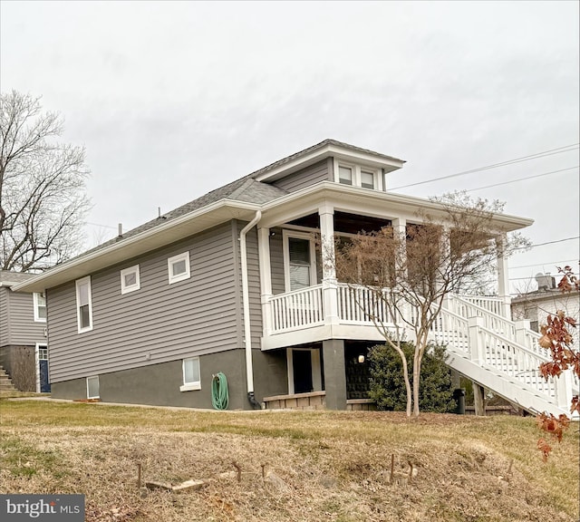 rear view of house with a porch and stairway