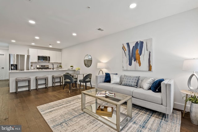 living room with dark hardwood / wood-style flooring