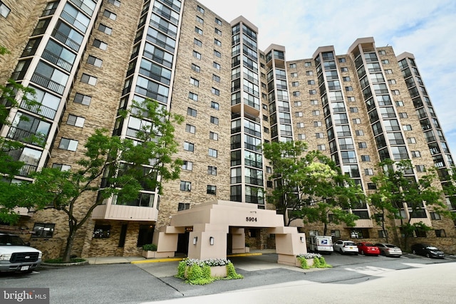 view of building exterior featuring uncovered parking