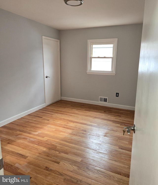 spare room with light hardwood / wood-style flooring