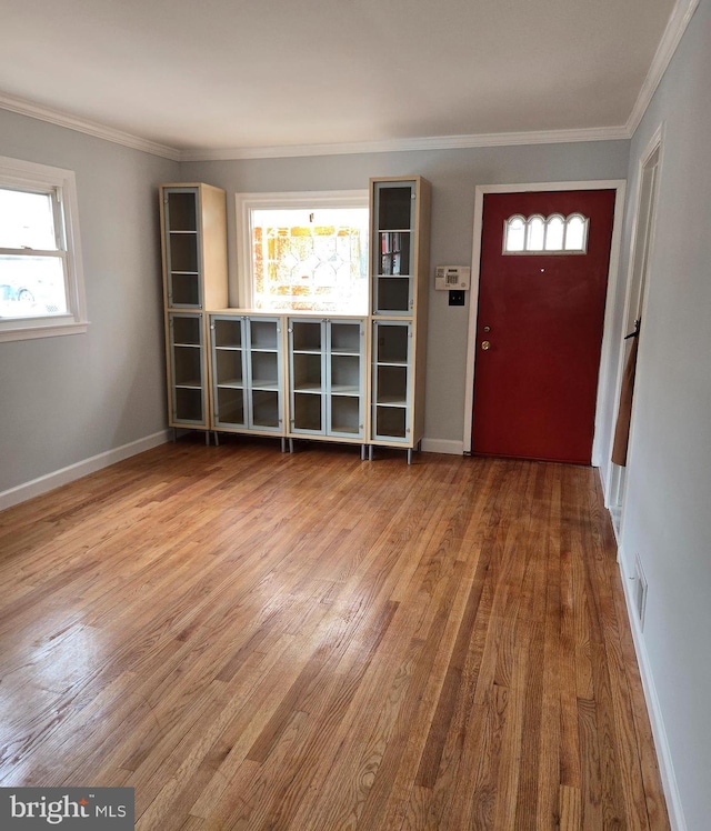 entryway with hardwood / wood-style flooring and ornamental molding