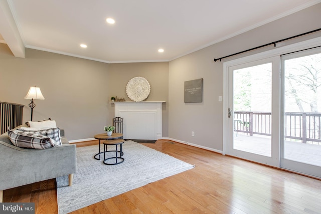 interior space featuring light wood-style flooring, baseboards, recessed lighting, and crown molding