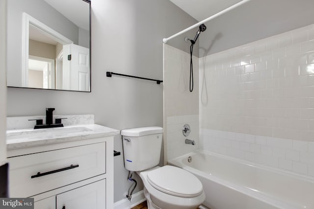 full bathroom featuring toilet, vanity, and  shower combination