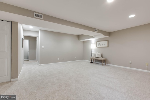 finished basement featuring recessed lighting, visible vents, baseboards, and light carpet