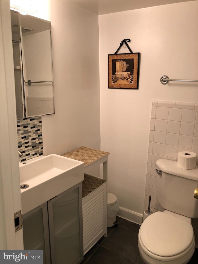 bathroom with tile patterned flooring, vanity, backsplash, and toilet