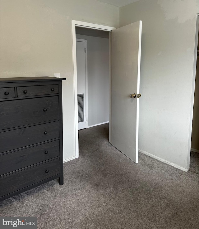 unfurnished bedroom featuring dark carpet