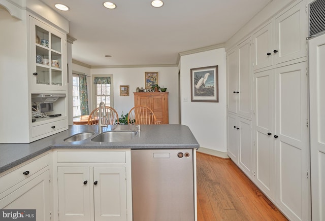 kitchen featuring sink, ornamental molding, white cabinets, and light wood-type flooring