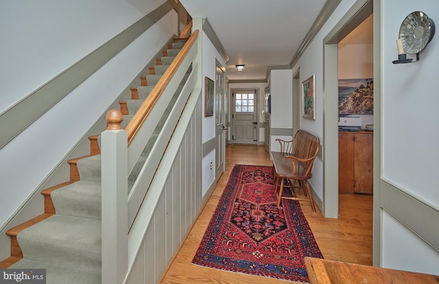 interior space with crown molding and light hardwood / wood-style flooring