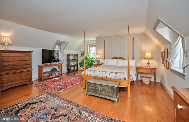 bedroom with hardwood / wood-style flooring and vaulted ceiling