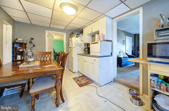 dining area featuring a drop ceiling