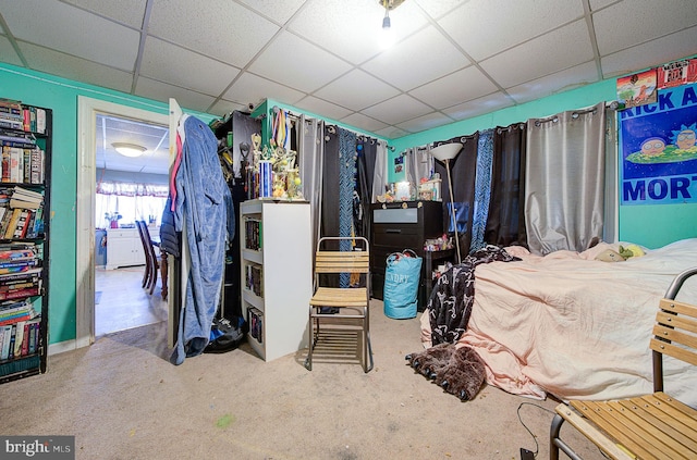 carpeted bedroom with a drop ceiling