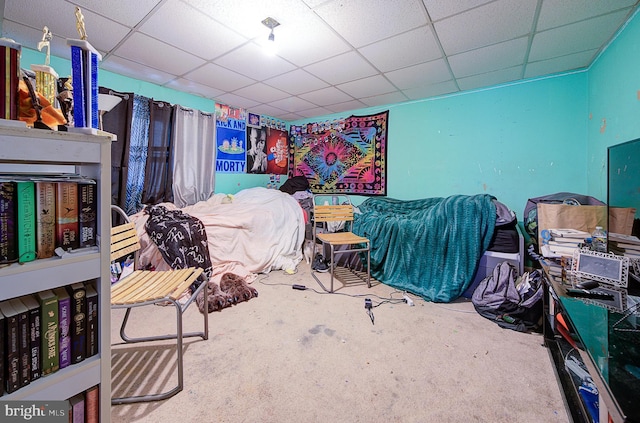 carpeted bedroom with a paneled ceiling