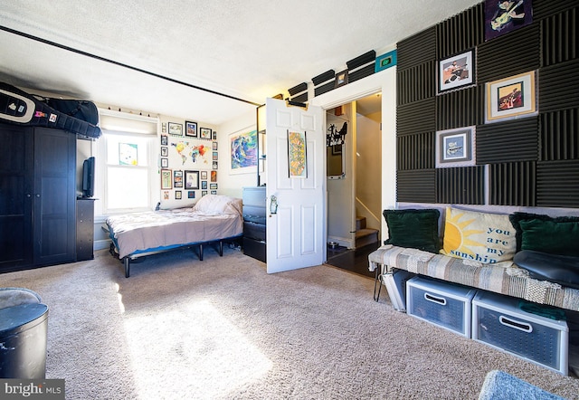 carpeted bedroom featuring a textured ceiling