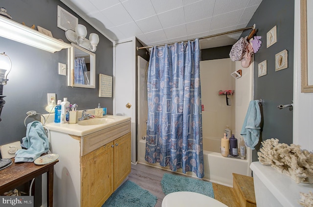 full bathroom with vanity, toilet, shower / tub combo, and wood-type flooring