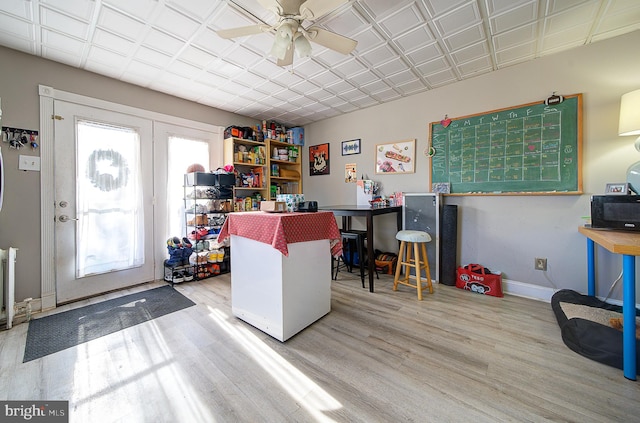 office featuring light hardwood / wood-style floors, french doors, and ceiling fan