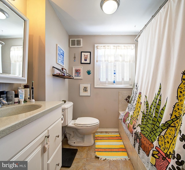 bathroom with vanity, toilet, and curtained shower