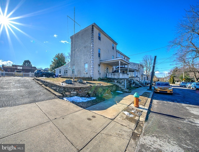 rear view of property featuring covered porch