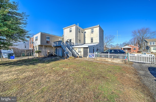 back of house with a yard and a deck