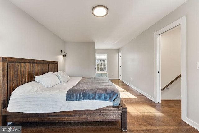 bedroom with baseboards and wood finished floors