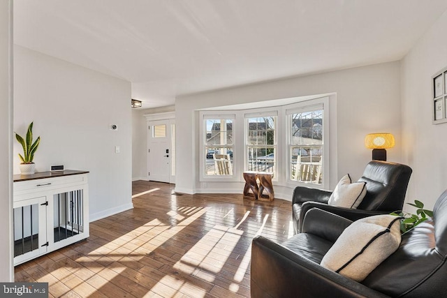 living room featuring dark wood-style flooring and baseboards