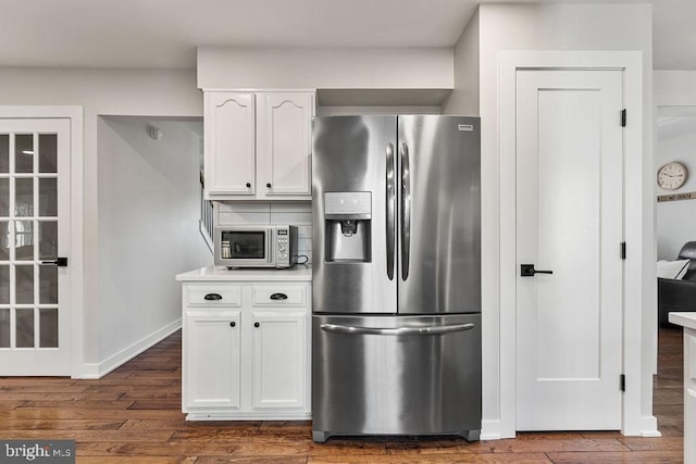 kitchen featuring dark wood-style floors, light countertops, baseboards, white cabinetry, and stainless steel appliances