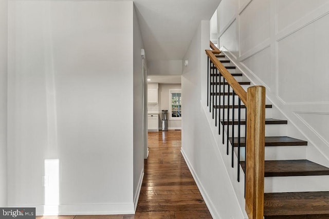 stairway featuring baseboards and wood finished floors