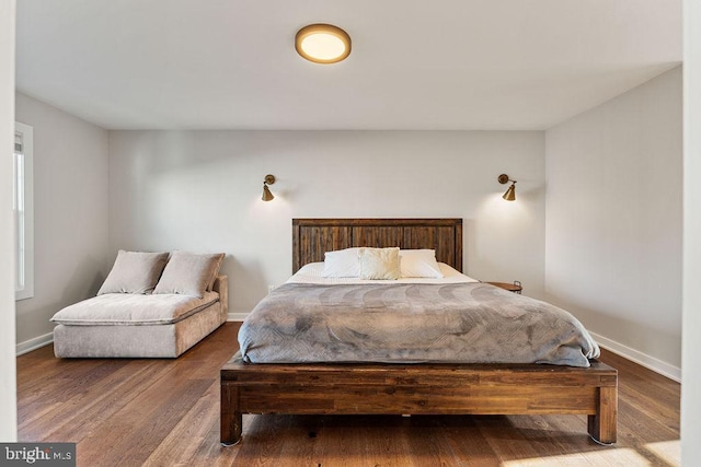 bedroom featuring baseboards and wood finished floors