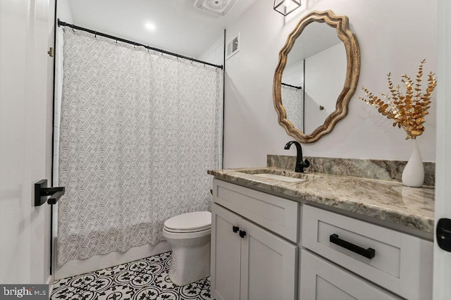 full bathroom with visible vents, toilet, vanity, and tile patterned flooring