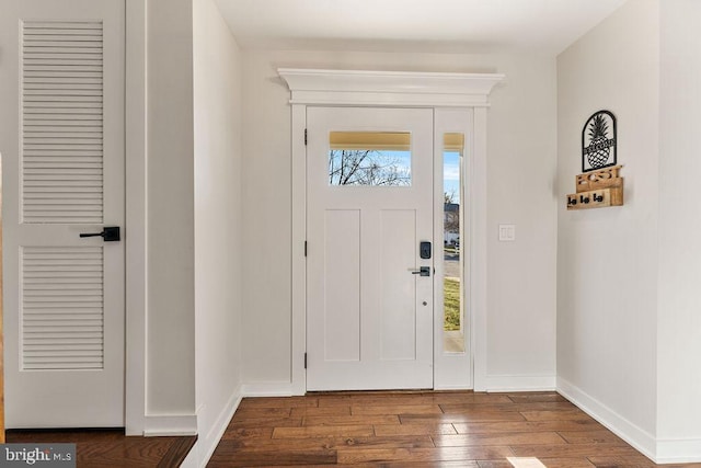 foyer entrance featuring baseboards and wood finished floors