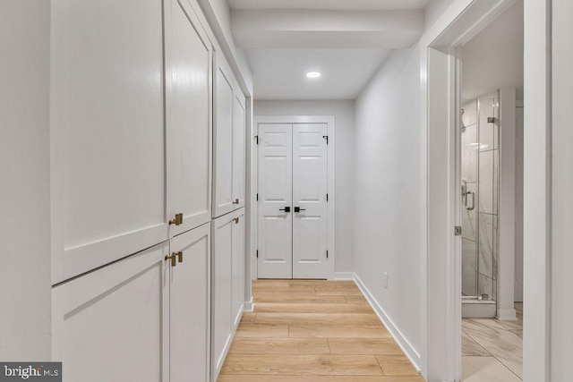 hall with light wood-style flooring, baseboards, and recessed lighting