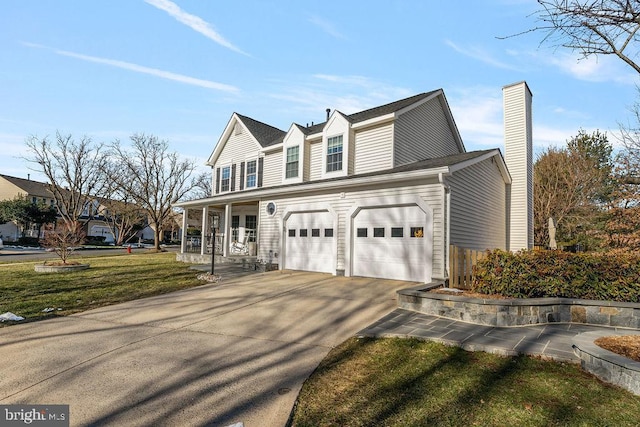 view of front facade featuring a front lawn, covered porch, driveway, and a garage