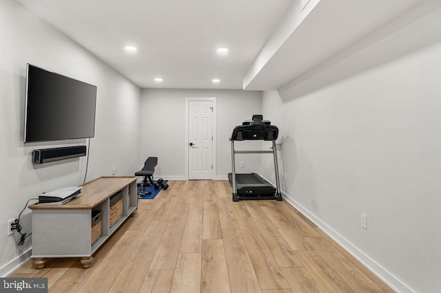 exercise room featuring baseboards, recessed lighting, and light wood-type flooring