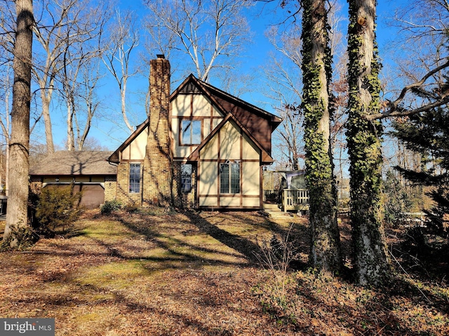 rear view of house with a chimney and brick siding