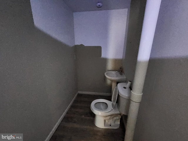 bathroom featuring toilet and hardwood / wood-style floors