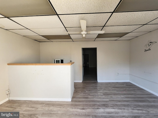 spare room featuring hardwood / wood-style floors, a paneled ceiling, and ceiling fan