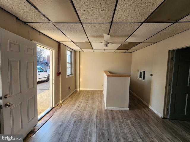 interior space with a paneled ceiling and wood-type flooring