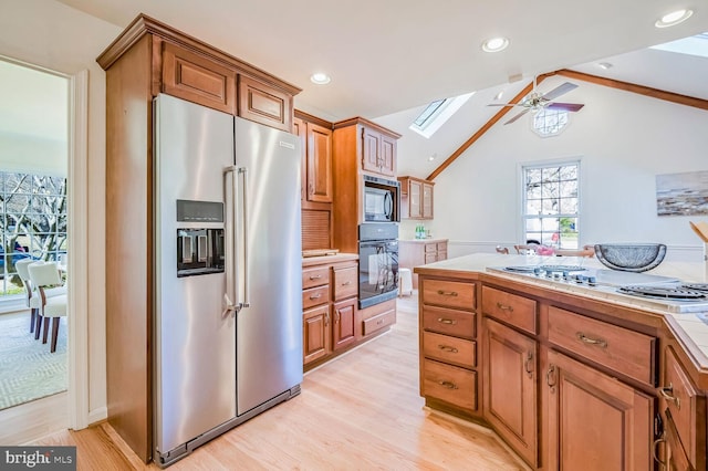 kitchen with stovetop, high quality fridge, built in microwave, tile countertops, and oven