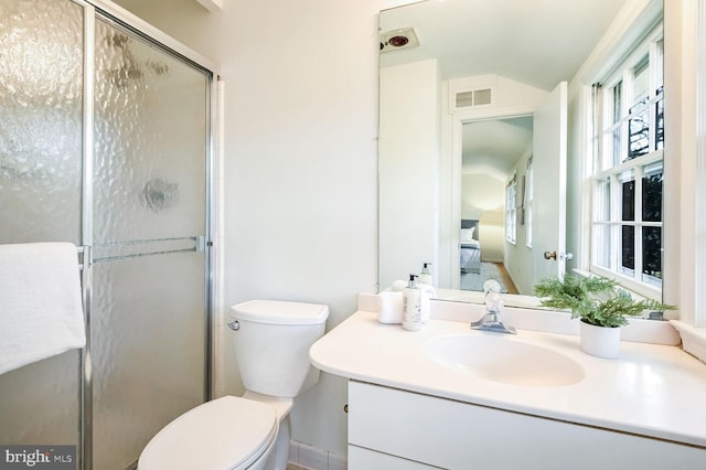 bathroom with walk in shower, vanity, and toilet