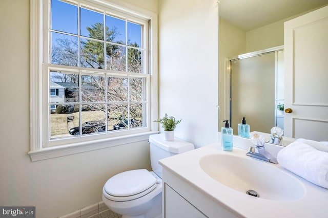 bathroom featuring vanity, toilet, and walk in shower