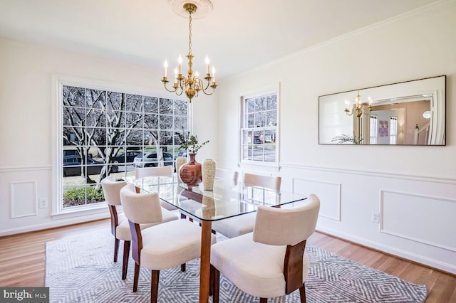 dining space featuring an inviting chandelier, wood-type flooring, and plenty of natural light