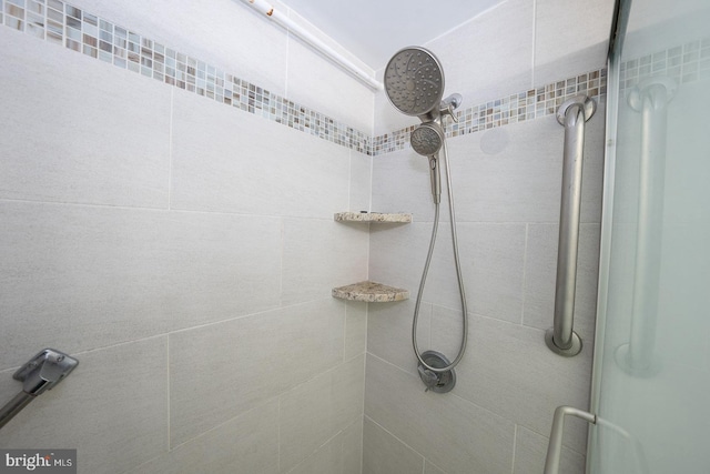 bathroom with tiled shower