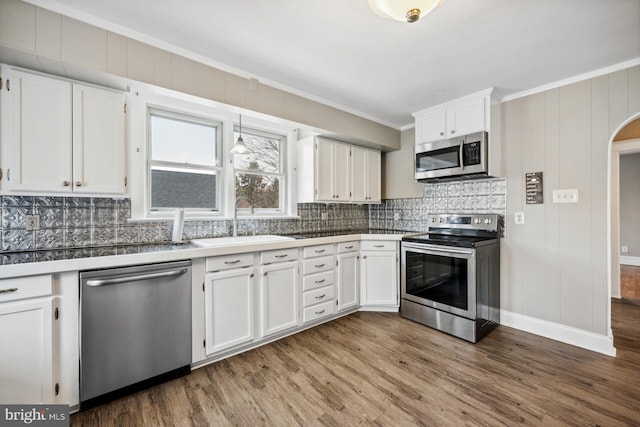 kitchen with white cabinetry, sink, hardwood / wood-style floors, and appliances with stainless steel finishes