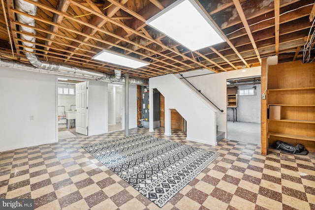 basement with plenty of natural light, sink, and heating unit